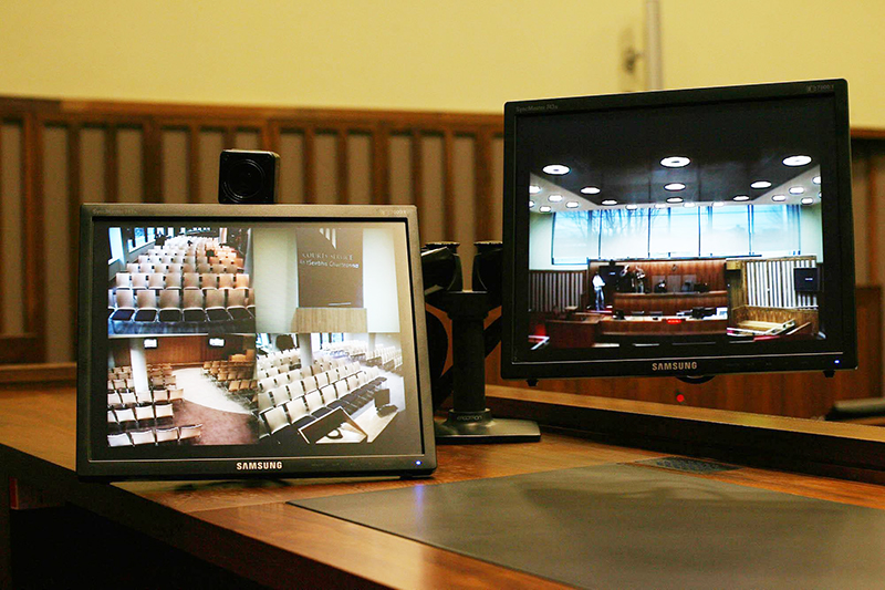 two device screens showing a courtroom